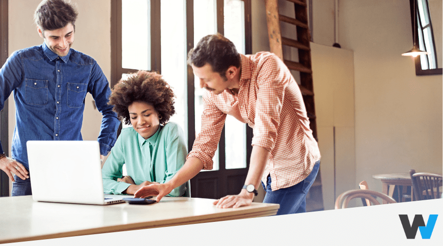 young professionals looking at laptop and calculator