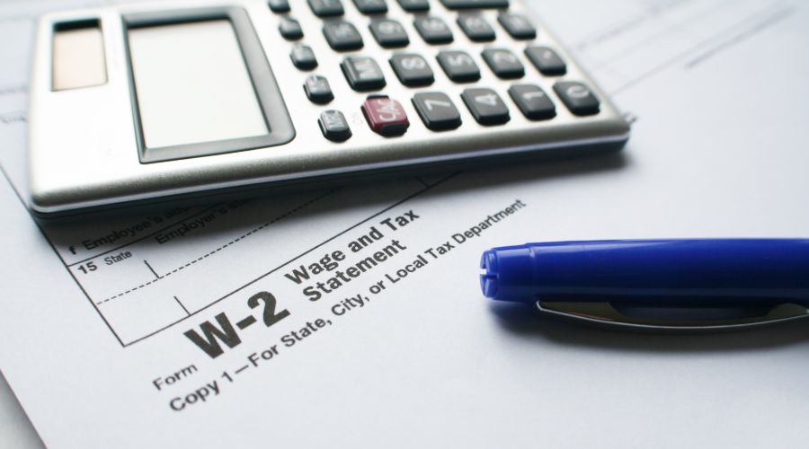 Tax Form W-2 With Calculator & Pen