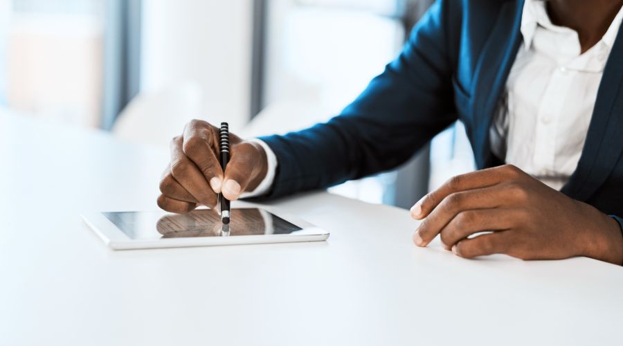 businesswoman using tablet to set goals for the new year