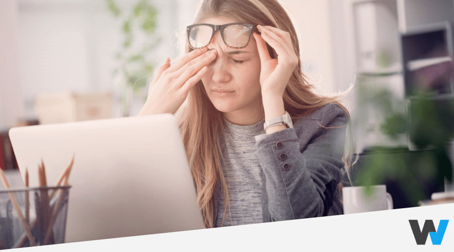 tired businesswoman in glasses working at office and rubbing eyes