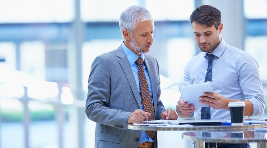 two businessmen looking at tablet