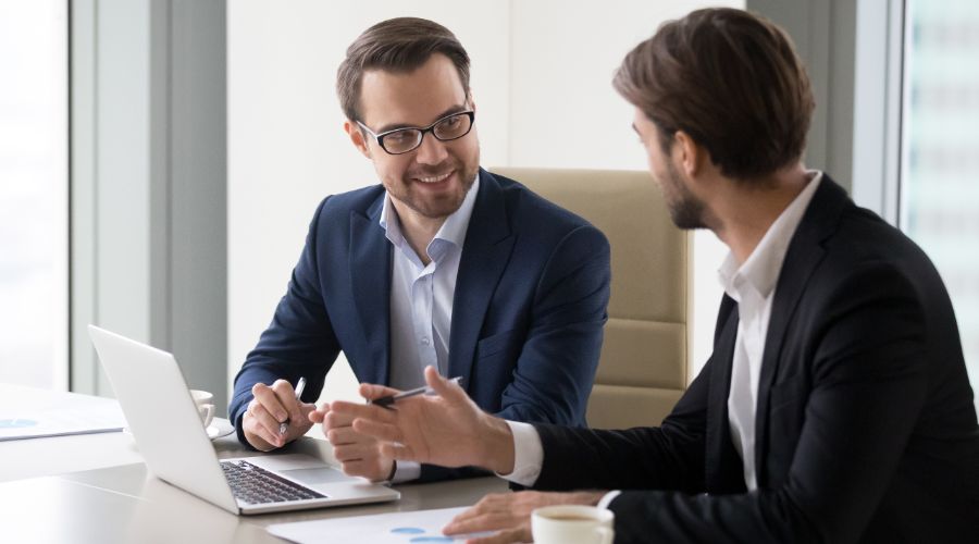 man explaining health insurance options to small business owner