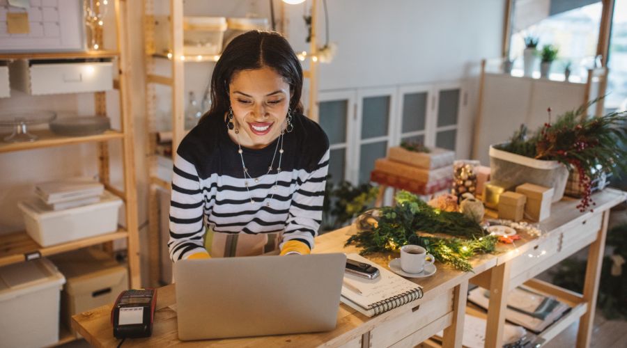 business owner checking holiday orders on computer