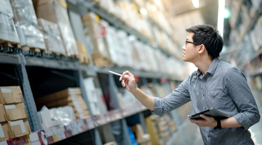 young man holding a tablet and checking the inventory