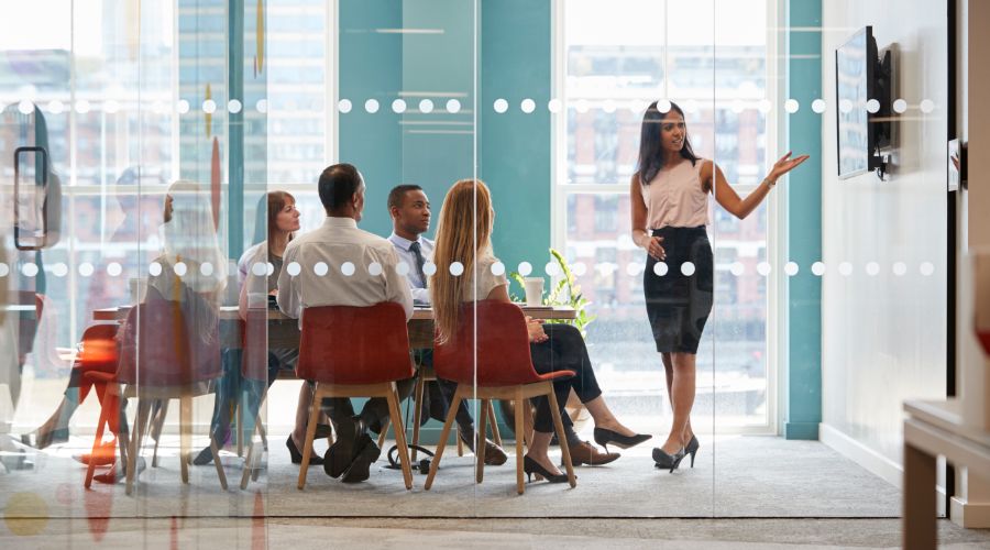 professional woman running a meeting with a small business team