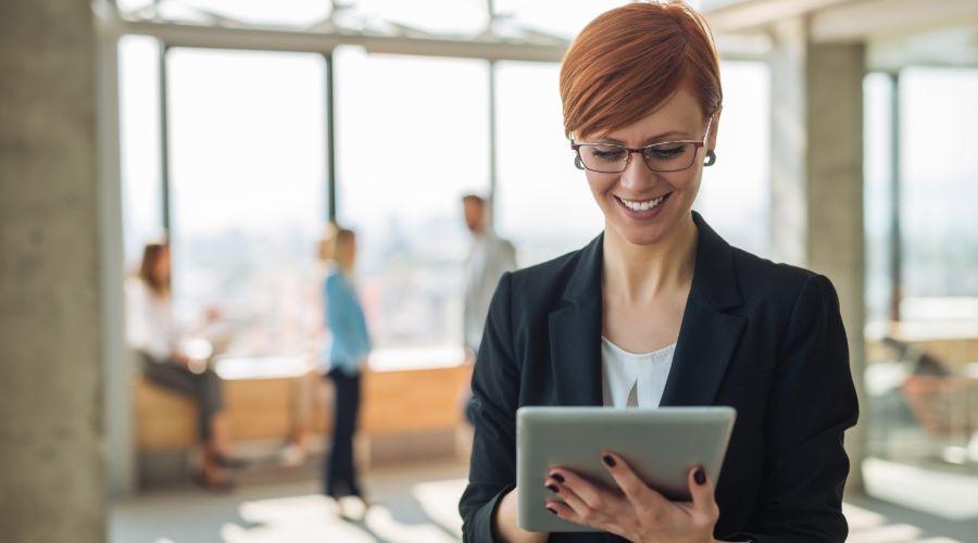 woman looking at Workful's payroll software on a tablet