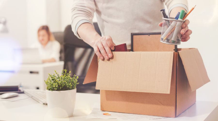 Employee packing up desk because he quit.