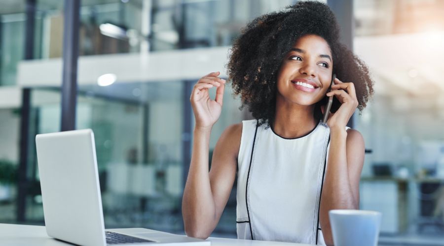 Small business owner on phone discussing her HR software choices