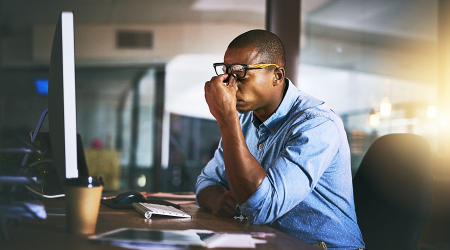 A stressed out small business owner looking at his computer screen