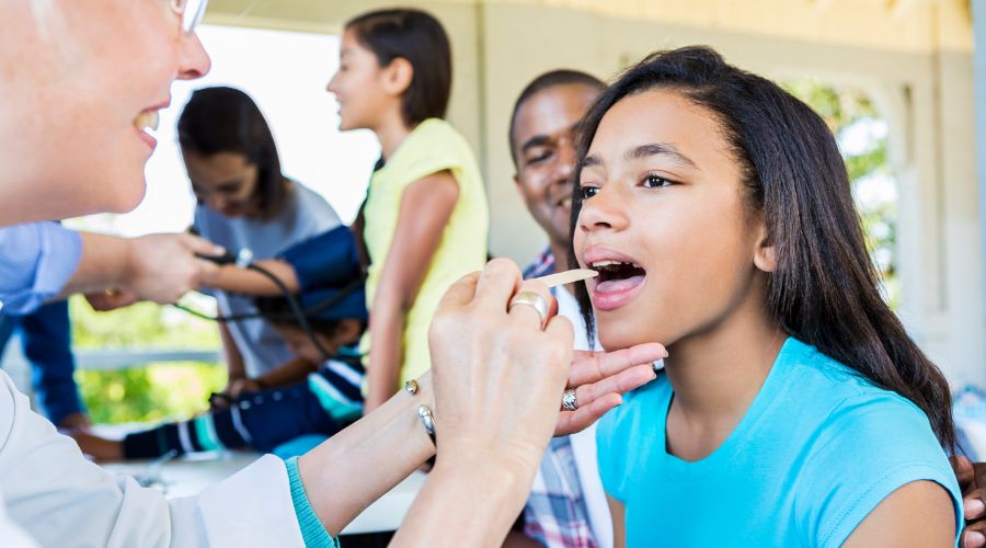 Child receiving a medical check-up from a doctor