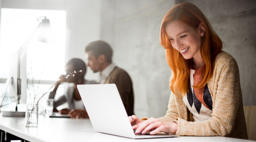 Employee smiling after learning she received a pay raise