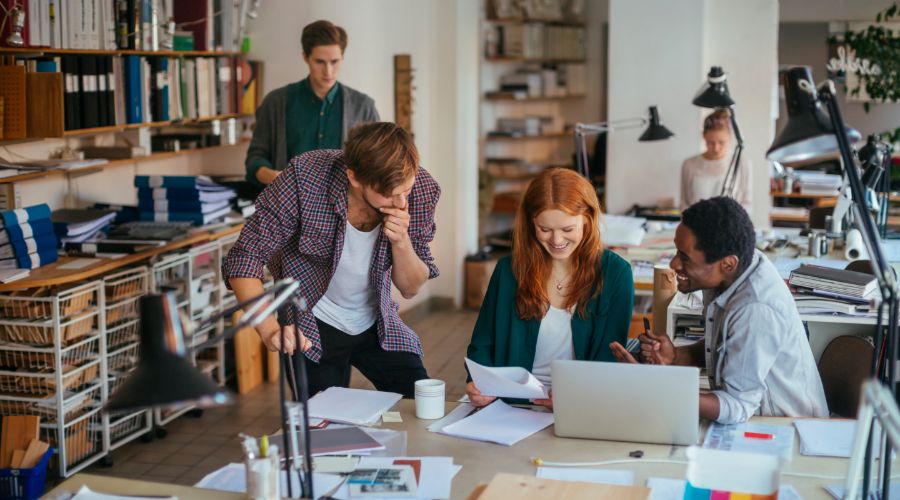 group of millennial workers reviewing a challenging new project