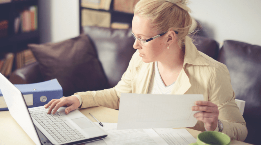 HR manager looking over employee information on a laptop