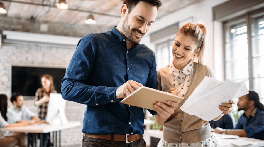 Professional man and woman reviewing onboarding checklist