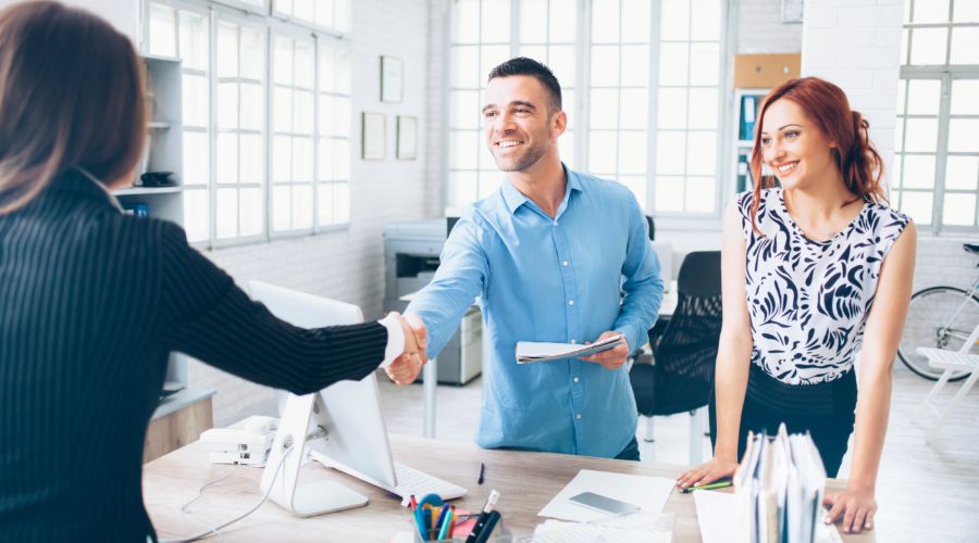 Professional man shaking hands with professional woman