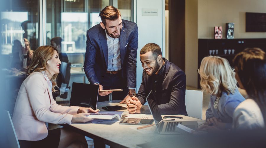 Small business owner having a meeting with his team