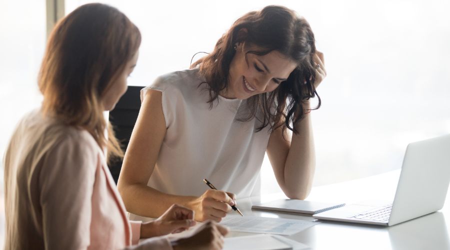 Small business owner reviewing career goals with an employee